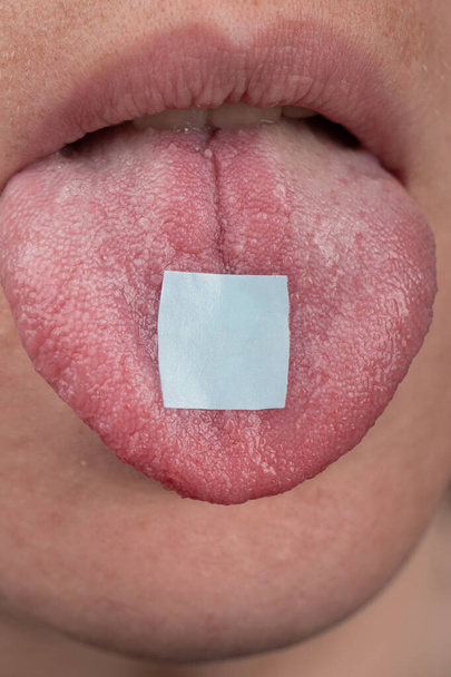 hippie use lsd mark ,lysergic acid in tongue closeup. - Photo, image