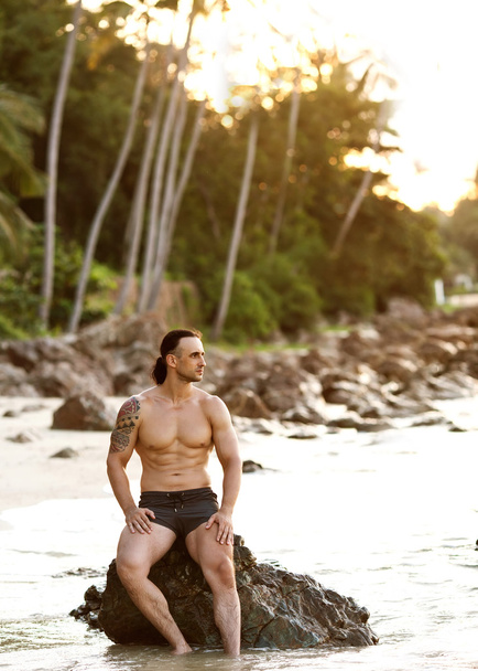 man practice yoga on the beach at sunset - Foto, Imagem