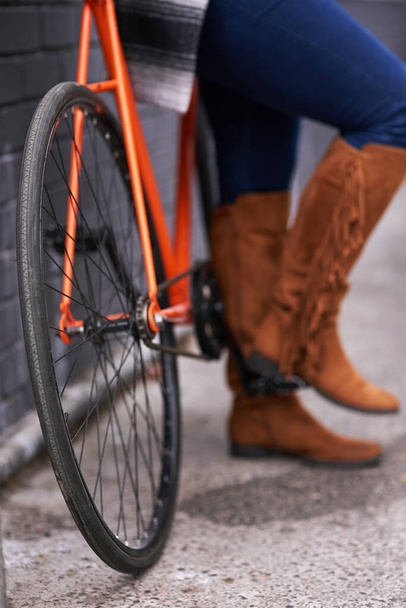 Bike wheels. a woman standing alongside a bicycle - Photo, Image