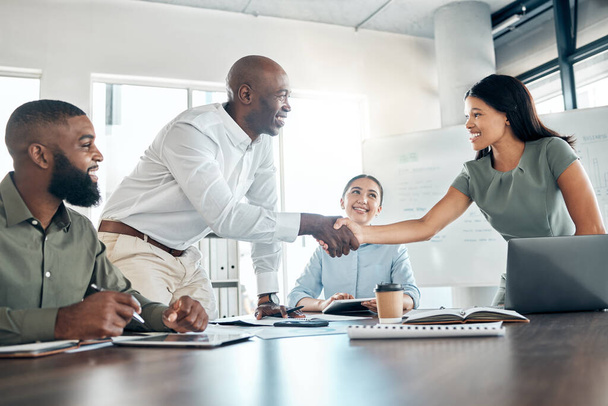 Handshake, office diversity and meeting welcome for company onboarding or partnership together. Introduction, agreement and negotiation with workforce people in corporate company boardroom - Photo, image