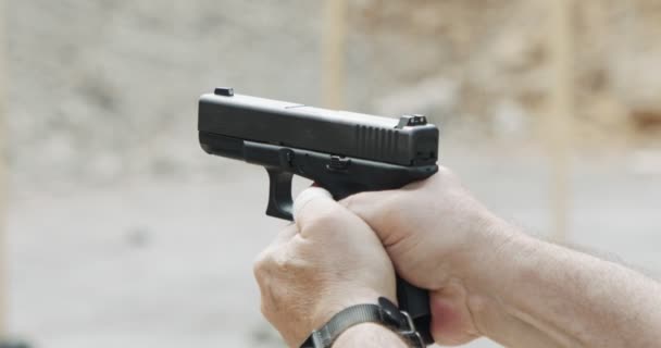 Pistol shooting bullets in slow motion footage. Hand guns in shooting range - Filmagem, Vídeo