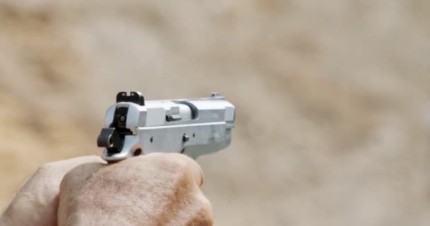 Pistol shooting bullets in slow motion footage. Hand guns in shooting range - Metraje, vídeo