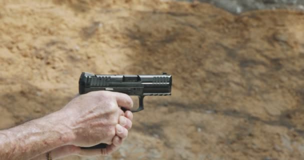 Pistol shooting bullets in slow motion footage. Hand guns in shooting range - 映像、動画