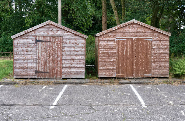 Brown wood sheds in rural countryside car park UK - Fotó, kép