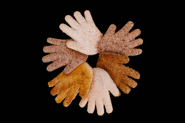 Multicultural hands together in a circle made from toasted bread on a black background - Φωτογραφία, εικόνα