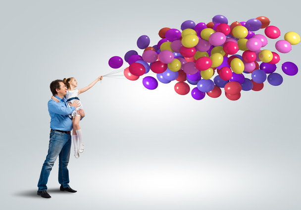 Happy family with bunch of balloons - Foto, Imagen