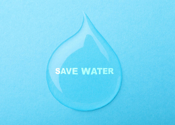 Save Water concept. Drop on light blue background - Φωτογραφία, εικόνα