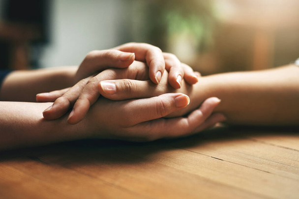 Blessed are those who willingly offer their help and support. Closeup shot of two unidentifiable people holding hands in comfort - Fotografie, Obrázek