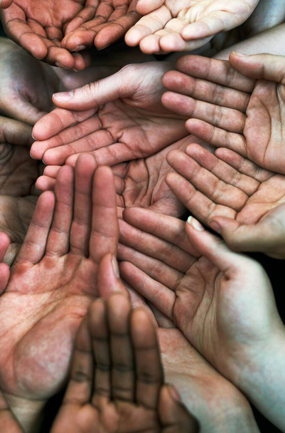 Please support us. a group of hands held cupped out together - Foto, Bild