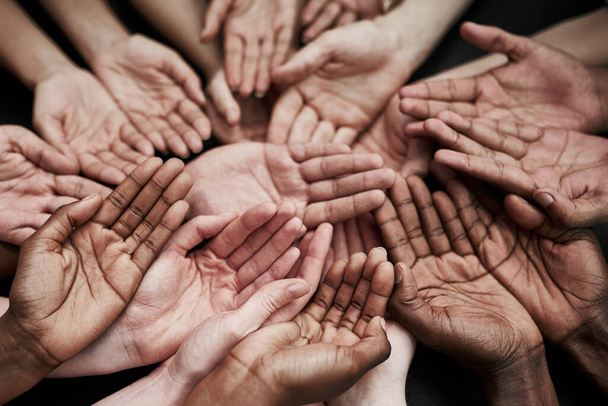 We cant help everyone, but everyone can help someone. a group of hands held cupped out together - Photo, Image
