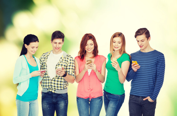 smiling students with smartphones - Photo, image