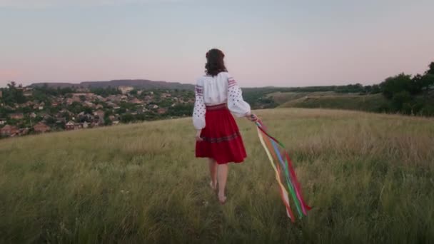 happy young woman enjoying the sunset, wearing traditional ukrainian clothes. lifestyle in Ukraine - Video
