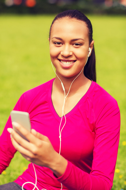 smiling african american woman with smartphone - 写真・画像