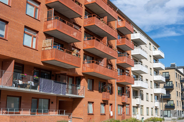 Red and white apartment buildings with many balconies seen in Berlin, Germany - Photo, Image