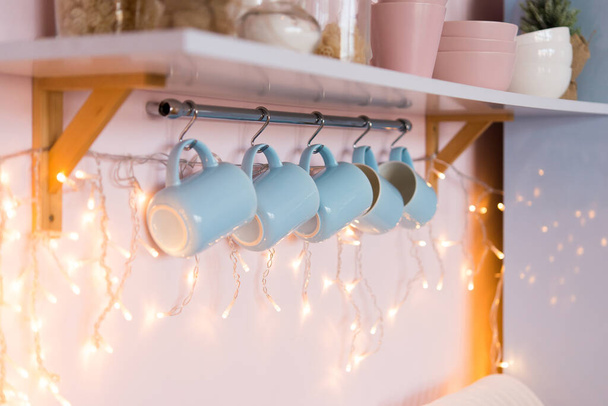 modern kitchen interior. new year and christmas decorations with decorative lamps. - 写真・画像