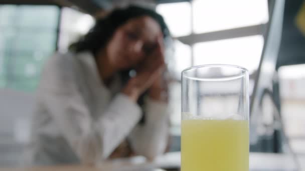 Focus on glass with medication young tired unhealthy woman manager office worker suffers headache from overwork feels pain due to computer fatigue pressure needs painkillers remedy treatment concept - Footage, Video