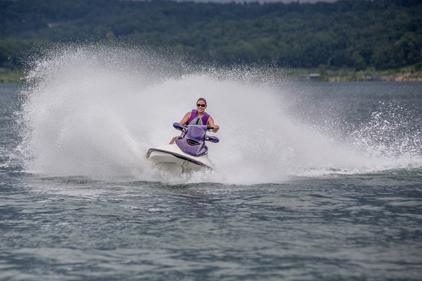 Yound Woman riding a jet ski - Photo, Image