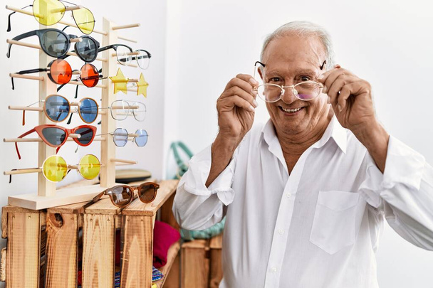 Senior man customer wearing glasses at clothing store - Fotografie, Obrázek