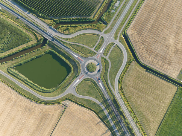 Roundabout junction aerial vehicle auto motorway intersection. Transportation safety crossroad. Circular ring road infrastructure street. - Foto, Imagen
