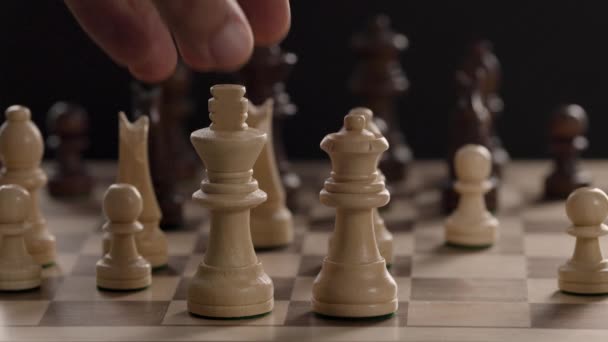 A hand moving a piece on a chess board - Felvétel, videó
