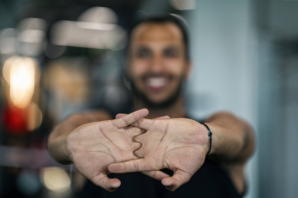 Closeup Shot Of Smiling Black Male Athlete Stretching Fingers Before Sport Training, Happy Young African American Man Warming Up Arm Muscles While Working Out At Gym, Selective Focus - Foto, Imagen