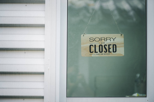 Sorry we're closed sign. grunge image hanging on a  glass door. - Φωτογραφία, εικόνα