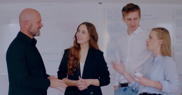 Group of business people discussing in office or financial report, businessman, businesswoman and manager talking on a project, brainstorming at meeting, shaking hands. Signing documents. - Materiał filmowy, wideo