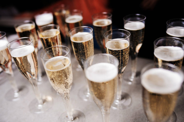 Champagne glasses on gold background. Party and holiday celebration concept - Photo, Image