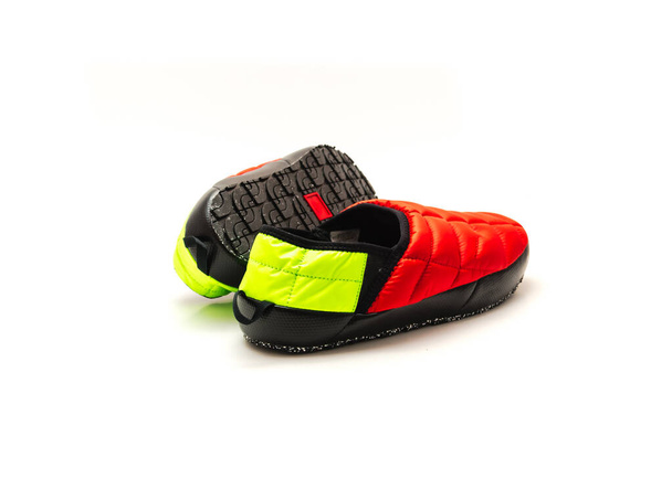 Brand new pair of red and green slip-on shoes mules with high-traction rubber outsole isolated on white background. Ripstop upper, collapsible heel warmth and comfort sneaker footgear. - Foto, Bild