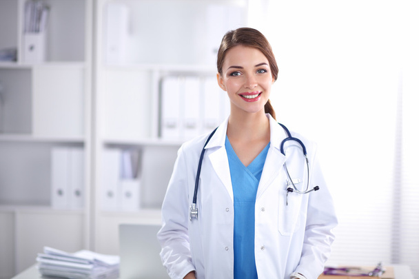 Portrait of happy successful young female doctor holding a stethoscope - Foto, immagini