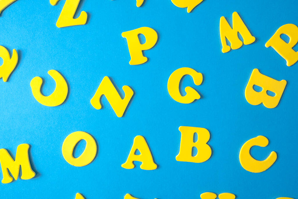 Colorful letters of the alphabet on a blue background. Elementary school or preschool, kindergarten. educational game. learning through play. High quality photo - Fotó, kép