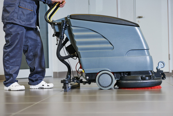 worker cleaning floor with machine - Photo, image
