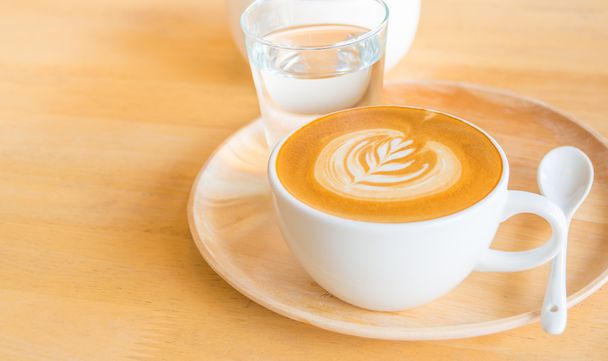 A Latte Coffee art on the wooden desk. - Foto, imagen