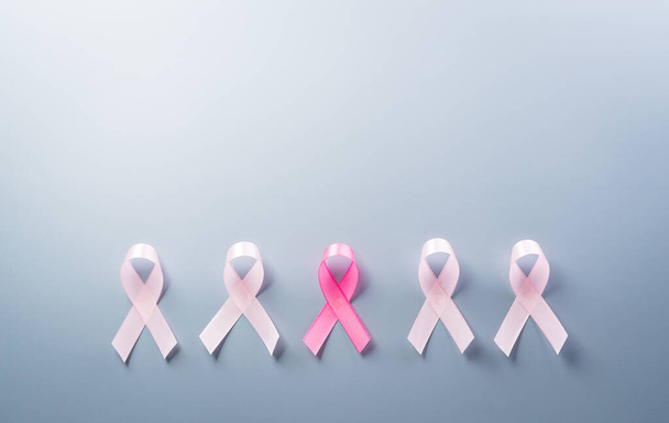 Pink ribbon on pastel paper background for supporting breast cancer awareness month campaign. - Valokuva, kuva