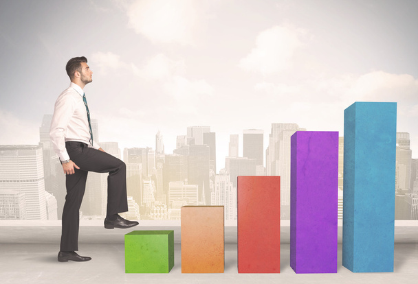 Business person climbing up on colourful chart pillars concept - Photo, Image