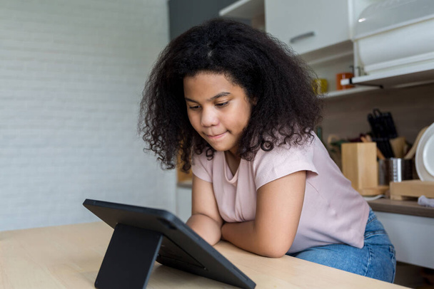 Girl using tablet and social media. Child playing on her digital tablet - Foto, Imagem