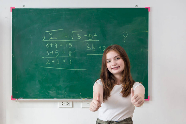 Kid write on chalk board. Back to school. Schoolchild in class. Happy kid writing green blackboard. - Fotó, kép