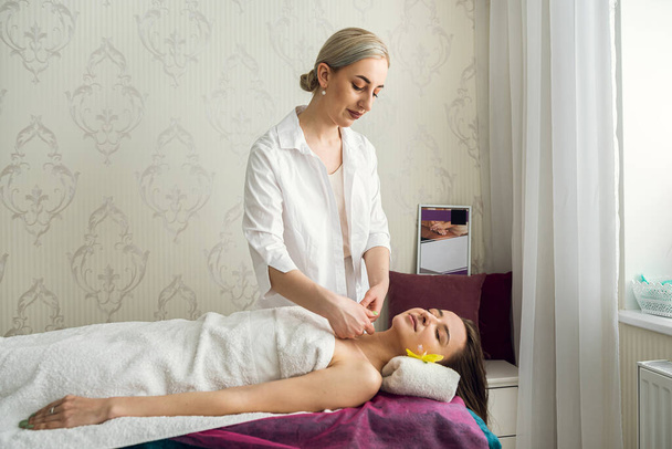 Osteopath makes manual neck massage her female client  in spa centre. healthy lifestyle - Foto, immagini