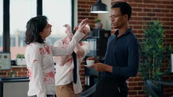 Brain dead zombie woman touching businessman while discussing. Doomsday survivor talking with dangerous dead walking corpse having bloody and deep wounds in office workspace. - Footage, Video