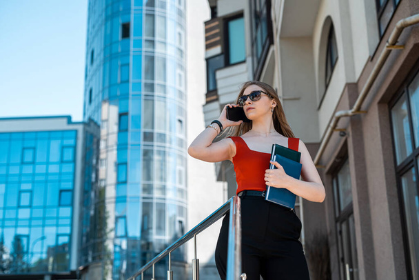 Business confident successful young professional businesswoman in suit standing near office building with arms crossed. Business concept - Foto, Bild