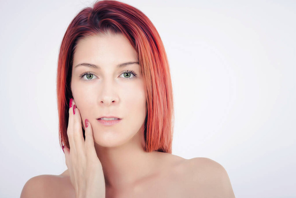 beautiful redhead woman with fresh and clean skin touching her face.  - Foto, imagen