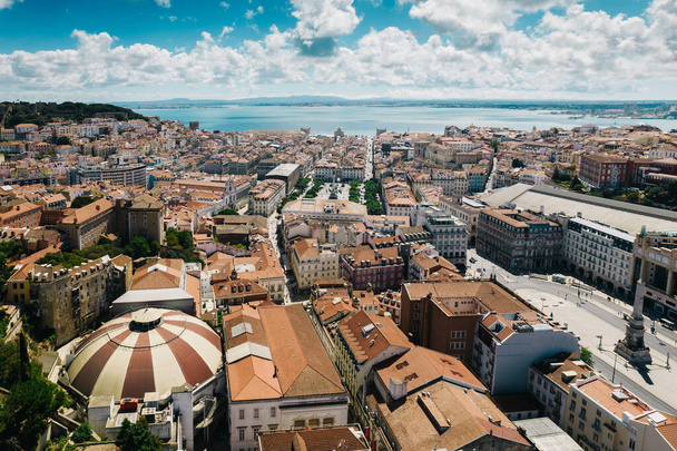 Aerial drone view of Baixa District in Lisbon, Portugal with major landmarks visible, next to the Tagus River - Foto, imagen