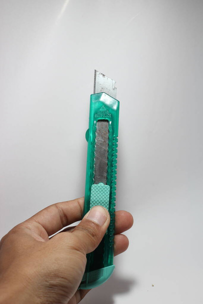 Rusty cutter knife and green case on white background  - Zdjęcie, obraz
