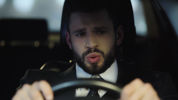worried man in formal wear driving automobile in evening - Zdjęcie, obraz