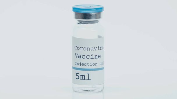bottle with coronavirus vaccine, only injection lettering isolated on white - Foto, afbeelding