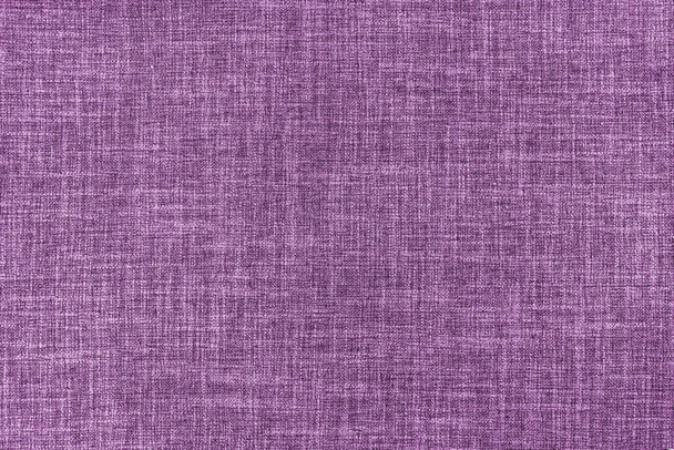 Texture of natural purple upholstery fabric or cloth. Fabric texture of natural cotton or linen textile material. Purple canvas background. Decorative fabric for curtain, furniture, walls, clothes - Fotó, kép