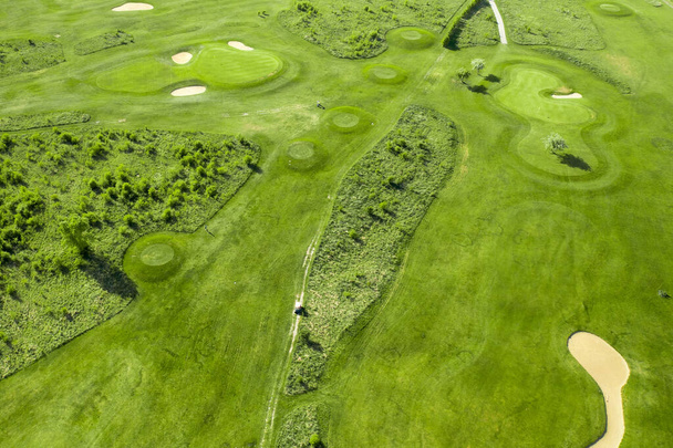 Golf course with sand bunker and green grass, aerial view. - Foto, afbeelding