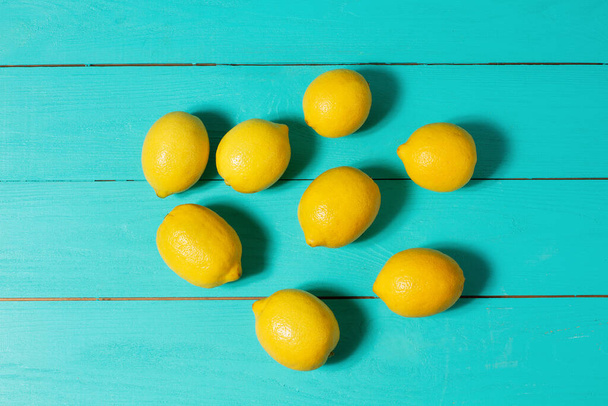 Summer background. Blue wooden table. Lemon food fruit. Top view, mock up and copy space. - Photo, image