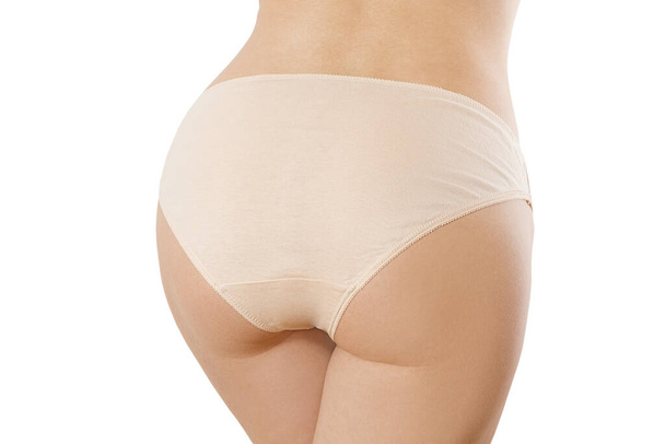 Close up woman butt in beige panties isolated. Female blank template underwear back view with copy space and mockup. Mock up lingerie. Body health, beauty concept. Anti cellulite, shaving bikini line - Photo, image