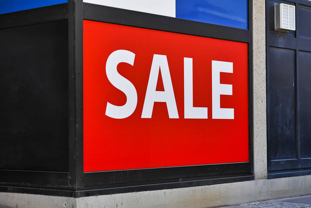Large red SALE sign in front of shop - Photo, Image